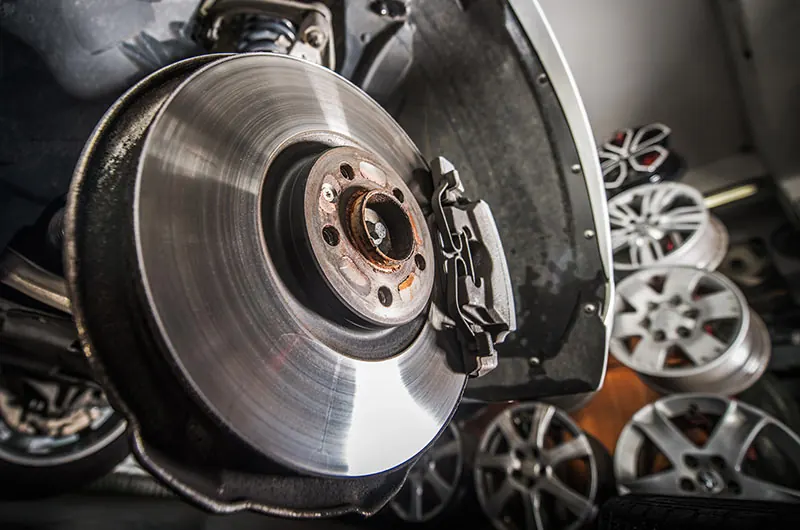 Worn brake disc being replaced during a brake service
