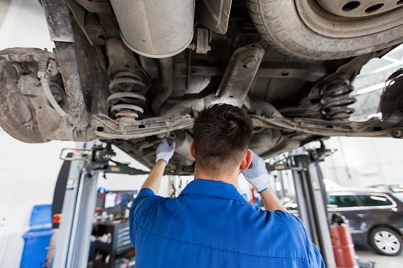 Mechanic performing a tune-up at the EC Auto Services workshop